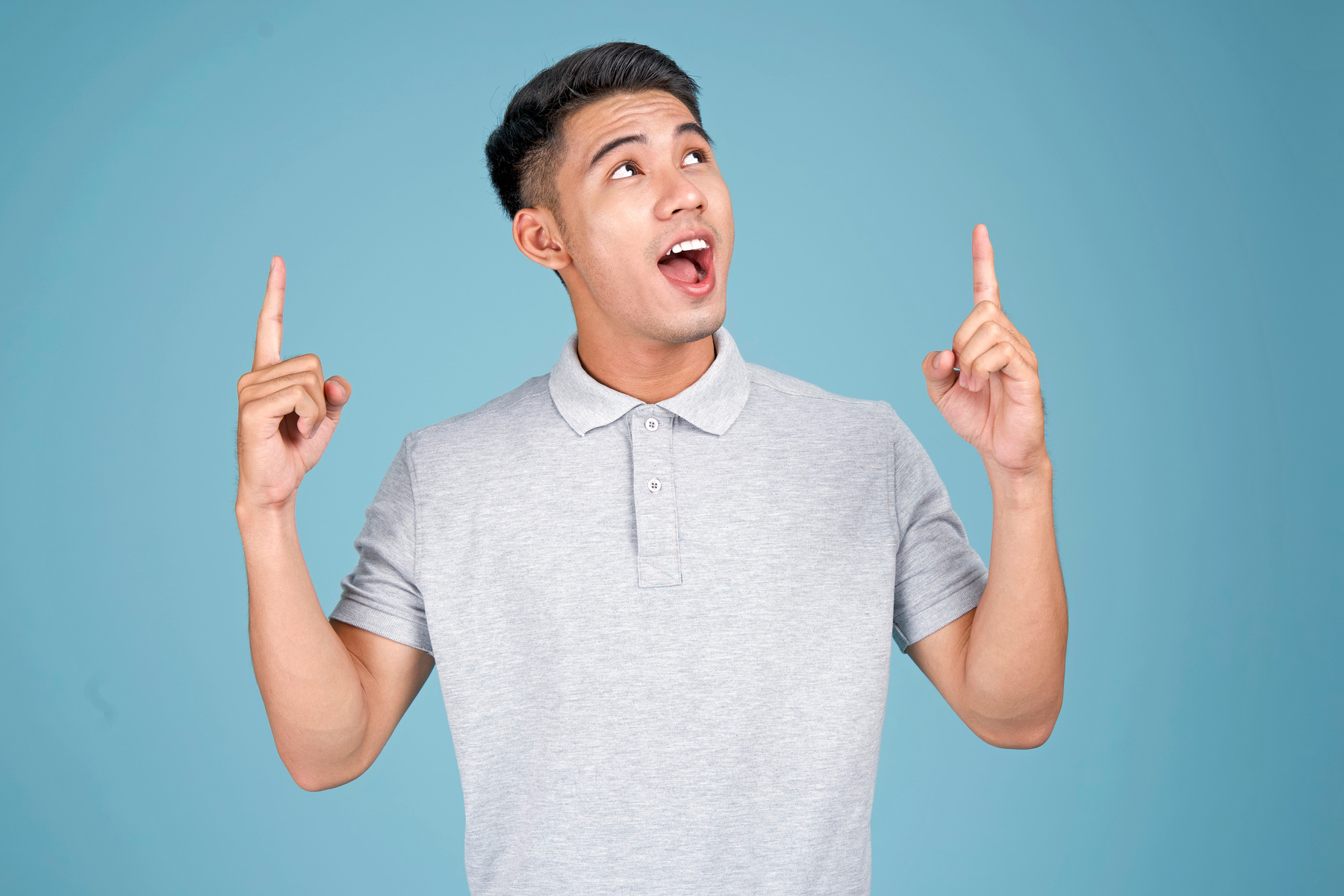 Man Pointing Upwards on Blue Background